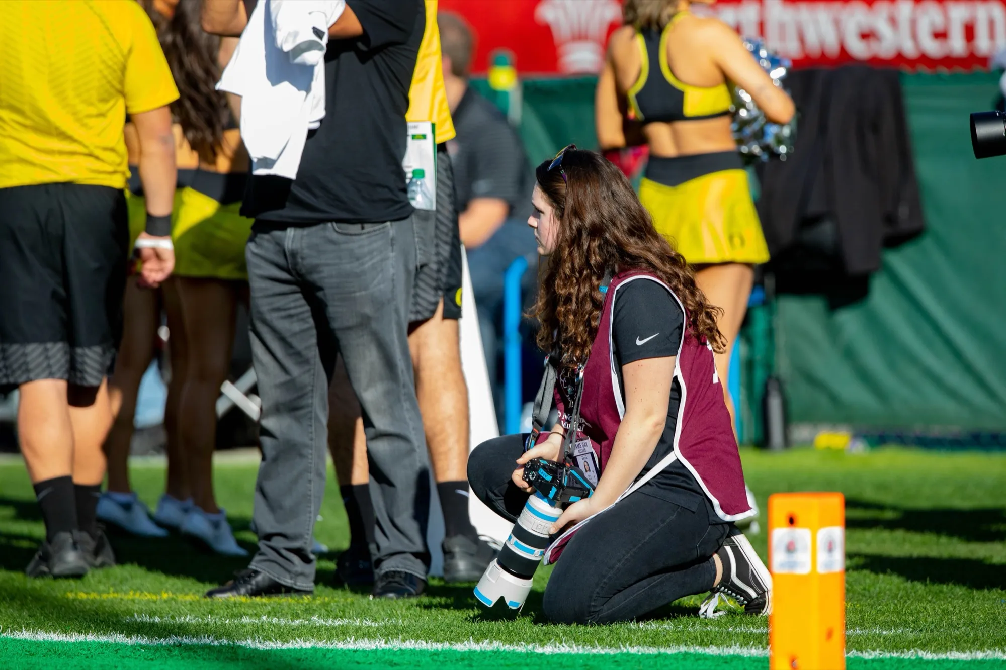 Marin shooting from the sideline at an Oregon Ducks football game